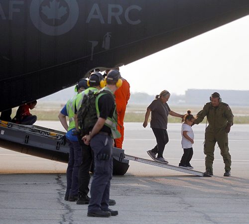 PHIL HOSSACK / WINNIPEG FREE PRESS  - Northern Manitoba fire evacuees step off of a Canadian Forces C130 Herculese transport arrives at James Richardson International Airport in Winnipeg Ferrying northern Manitoba fire evacuees south to shelter.- August 30, 2017
