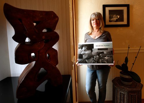 WAYNE GLOWACKI / WINNIPEG FREE PRESS

Bonnie Bricker at home, she is holding a photograph of her son Reid who died by suicide in 2015 after seeking care several times. At left is the last sculpture Reid completed titled LIFESART.  Bonnie  works for the Mood Disorders Association of Manitoba. Joel Schlesinger story August 31 2017