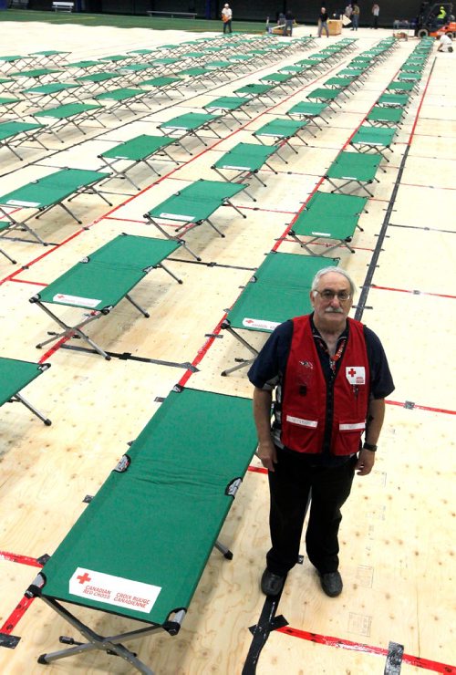 BORIS MINKEVICH / WINNIPEG FREE PRESS
Winnipeg, MB - This is a portrait of volunteer and site manager Bob Chochinov. Red Cross workers set up cots for fire evacuees this morning in the Winnipeg Soccer North indoor complex. They covered the artificial turf with thousands of sheets of plywood. BEN WALDMAN STORY. Sept. 1, 2017