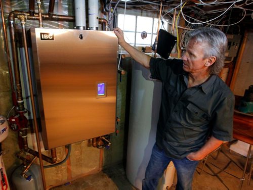 BORIS MINKEVICH / WINNIPEG FREE PRESS
Winnipeg, MB - Homes - Robert Boulet is the owner/operator of Priority Plumbing & Heating Ltd. Here is a shot of Boulet and a new boiler at a Westgate home. Sept. 1, 2017