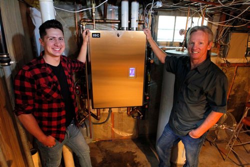 BORIS MINKEVICH / WINNIPEG FREE PRESS
Winnipeg, MB - Homes - Robert Boulet is the owner/operator of Priority Plumbing & Heating Ltd. Here is a shot, from left, of plumber in training Landon Buis and Robert Boulet  with a new boiler at a Westgate home. Sept. 1, 2017