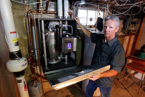 BORIS MINKEVICH / WINNIPEG FREE PRESS
Winnipeg, MB - Homes - Robert Boulet is the owner/operator of Priority Plumbing & Heating Ltd. Here is a shot of Boulet and a new boiler at a Westgate home. Sept. 1, 2017