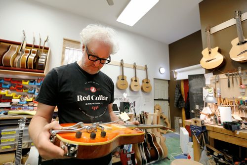 JUSTIN SAMANSKI-LANGILLE / WINNIPEG FREE PRESS
Al Beardsell inspects an electric guitar he made around 1996 that has found its way back into his workshop for some repairs.
170901 - Friday, September 01, 2017.