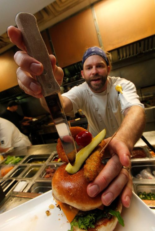PHIL HOSSACK / WINNIPEG FREE PRESS  -  STAND UP - Barley Brothers Chef Lorne Giesbrecht puts the finishing touches on the establishemnt's "We Draughted Caesar" burger. Their sandwich designed around Le Burger Week. See below.  - Sept 1, 2017

Le Burger Week kicks off today. 
Barley Brothers entry...

"We Draughted Caesar"

Inspired by our Barley Caesar, this bison burger is just the right combination of flavours. You will taste a beer inspired Caesar in every bite. The patty is topped with local old cheddar cheese, our made-in-house Clamato relish, beer mustard, beer and bacon jam, market fresh tomatoes, onions and leaf lettuce. No Caesar is complete without celery salt found rimmed on our brioche bun and of course garnished to the T! 

