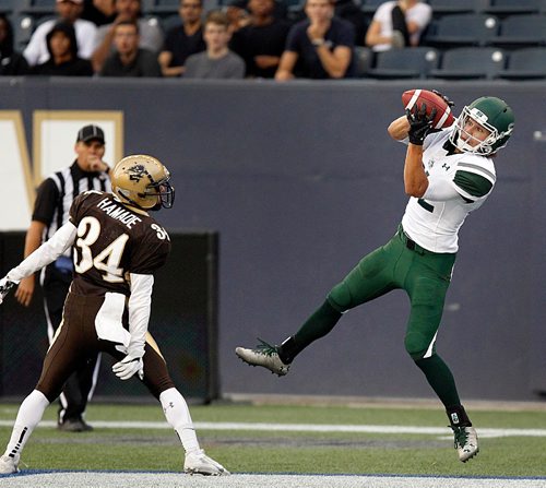 PHIL HOSSACK / WINNIPEG FREE PRESS  -  Saskatchewan Huskie #82 Evan Kopchynski takes the long pass to score the opening touchdown against the U of M Bisons Friday night at Investor's Group Field. Bison #34 Tanner Hamade watches. 
 - Sept 1, 2017


