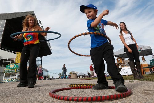 JOHN WOODS / WINNIPEG FREE PRESS
Karen Turnbull (L), owner of Kazual Art and Sol, shows Colton Harrisko (4) how to hula hoop at the Manitoba Night Market and Festival at Assiniboia Downs Sunday, September 3, 2017.

