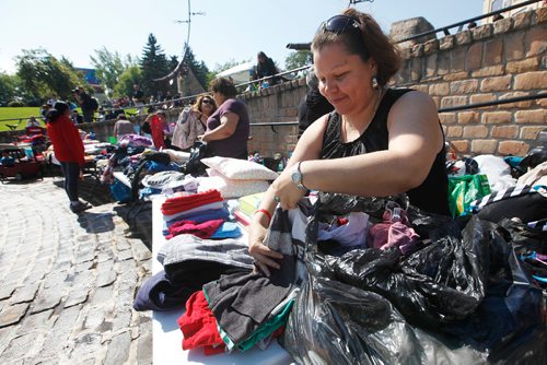 JOHN WOODS / WINNIPEG FREE PRESS
Priscilla Bone folds clothing at the clothing drop off at Concert of Hope for Northern Fire Evacuees at Odena Circle in Winnipeg Monday, September 4, 2017.
