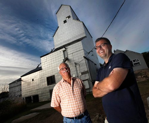 PHIL HOSSACK / WINNIPEG FREE PRESS  - Matt Bialek and his father Randy (left) stand in front of the Tyndall elevator Tuesday evening. Built on the origional trans-Canada rail line, Matt and his father Randy are trying to save the structure purchased from a grain company by Matts Grandfather in the 1970's. See Randy Turner's tale. - September 5, 2017