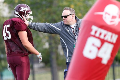 JOHN WOODS / WINNIPEG FREE PRESS
St Paul's Crusader coach Stacy Dainard works with D lineman Colin Cornelson during practice at the school Tuesday, September 5, 2017.