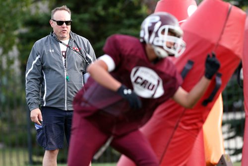 JOHN WOODS / WINNIPEG FREE PRESS
St Paul's Crusader coach Stacy Dainard looks on as his D linemen hit bags during practice at the school Tuesday, September 5, 2017. 
