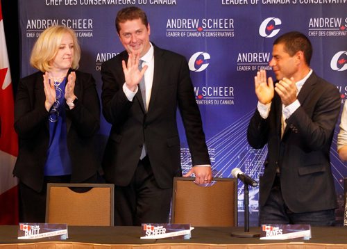 PHIL HOSSACK / WINNIPEG FREE PRESS  - Flanked by Deputy Leader Lisa Raitt (left) and MP Alain Rayes National Conservative Party Leader Andrew Scheer takes his seat at a meeting of his shadow cabinet in Winnipeg Wednesday. See Randy Turner's tale. - September 5, 2017