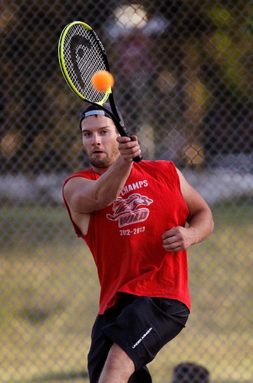 PHIL HOSSACK / WINNIPEG FREE PRESS  - STAND-UP - Nick Hildebrandt keeps a close eye on the ball as he volleys in a match with Joel Slawnych at Sir John Franklin Park Wednesday night, enjoying the game the fellowship and the weather. STANDUP  - September 5, 2017