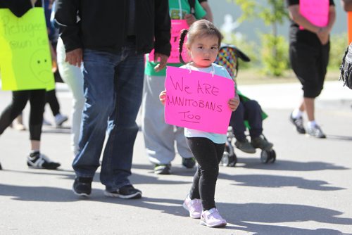 RUTH BONNEVILLE / WINNIPEG FREE PRESS 

A young Garden Hill first nation child, Madison Beardy (3yrs),  walks with her family and community members holding a sign saying "we are Manitobans too" in a protest walk from a soccer complex at 770 Lela Ave.,   (574  members of their community are being housed on cots) and heading to the Manitoba legislative building Thursday. The chief and community are  asking the provincial government to help house the  574 people from his community living at the soccer complex as well as hundreds more staying at RBC convention centre to be put up in hotels so they are not sleeping on cots. He's also asking the government to help put out the fires in their community so they can go home as soon as possible.

SEPT 07, 2017
