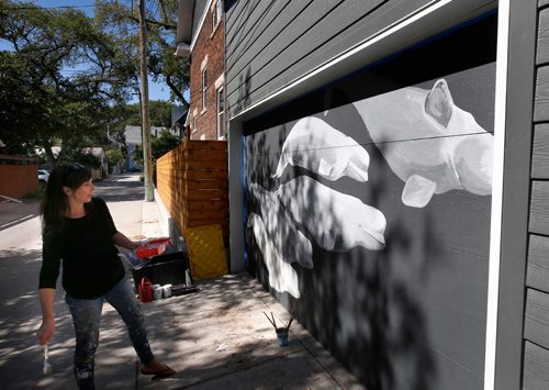 WAYNE GLOWACKI / WINNIPEG FREE PRESS

Winnipeg artist Kal Barteski has been painting arctic murals in the back lane between Ethelbert St. and Canora St. from Westminster south to Wolseley Ave. She is painting beluga whales on a garage door in photo.  This is being presented as part of Nuit Blanche.  Paintings  are on garage doors and smaller ones on panels affixed to the fences - it's called #Back Alley Arctic. Wendy King story   Sept. 8 2017