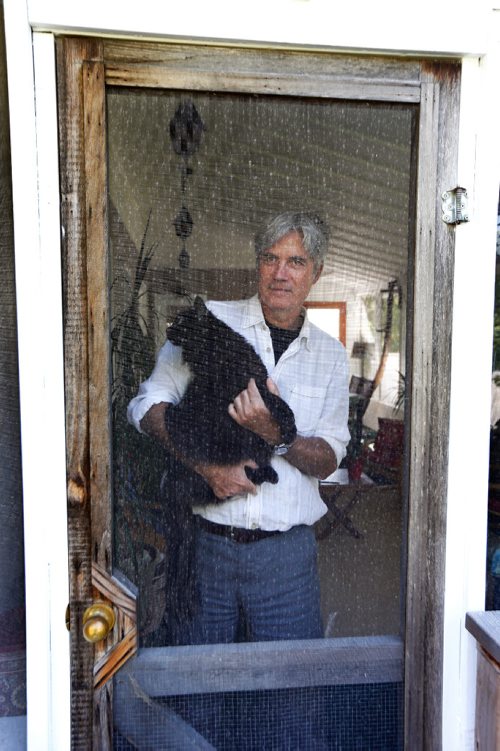 WAYNE GLOWACKI / WINNIPEG FREE PRESS
49.8 Cordell Barker, Academy Award-nominated animators 1988 film The Cat Came Back has just come out in book form. Here is Cordell in his back yard screened in porch with his cat Murphy. Dave Sanderson story Sept. 8 2017