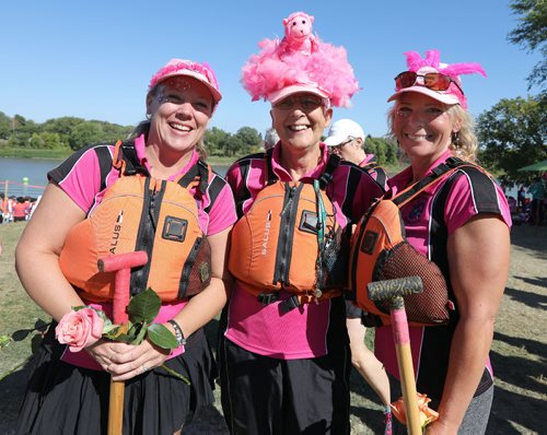 JASON HALSTEAD / WINNIPEG FREE PRESS

L-R: Members of the Dragon Tamers team from Kenora, Sarah Jell, Diane Pochailo and Rhonda McAmmond, prepare for the flower ceremony at the Canadian Cancer Society September Dragon Boat Challenge on Sept. 9, 2017 at the Manitoba Canoe & Kayak Centre. The flower ceremony involves flowers being placed in the water to honour those living with or taken by cancer. (See Social Page)