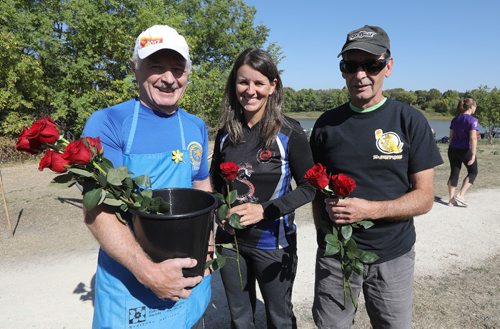 JASON HALSTEAD / WINNIPEG FREE PRESS

L-R: Roy Houston sells roses to Dominique Ostermann and Walter Koop of the Dirty Oars team at the Canadian Cancer Society September Dragon Boat Challenge on Sept. 9, 2017 at the Manitoba Canoe & Kayak Centre. The roses were for the flower ceremony in which flowers are placed in the water to honour those living with or taken by cancer.
 (See Social Page)