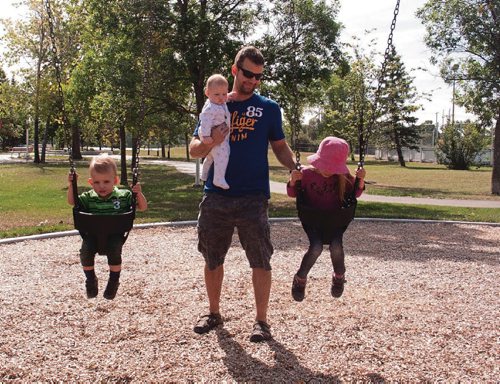 Canstar Community News Jeremy Semchyshyn with his children (from left) Felix, Zoey, and Caitlyn at the new Park City West Community Centre playground. (SHELDON BIRNIE/CANSTAR/THE HERALD)