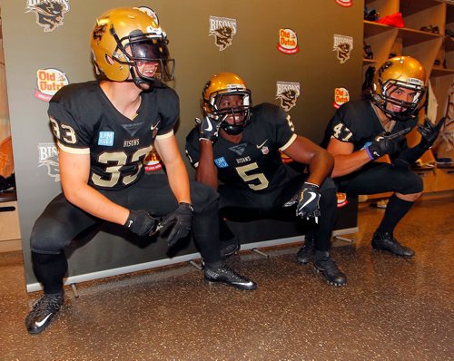 BORIS MINKEVICH / WINNIPEG FREE PRESS
Bison Sports presser in the Bison football dressing room at IGF. Bison Football unveiled their new jerseys. They are the first new uniforms for the program since the 2008 season. From left, #33 Alex Christie, #5 Akeeno Williams, #47 James Mau. Sept. 12, 2017