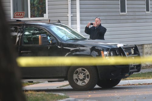 WAYNE GLOWACKI / WINNIPEG FREE PRESS
An Investigator photographs a vehicle (appears to be a police vehicle)  on Alfred Ave. at Powers St.  Police taped off section of Alfred Ave. between Andrews St. and Salter St. Wednesday morning after a serious incident. Carol Sanders story  Sept. 13 2017