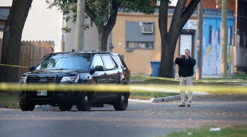 WAYNE GLOWACKI / WINNIPEG FREE PRESS

Investigators by a vehicle (appears to be a police vehicle)  on Alfred Ave. at Powers St.  Police taped off section of Alfred Ave. between Andrews St. and Salter St. Wednesday morning after a serious incident. Carol Sanders story  Sept. 13 2017