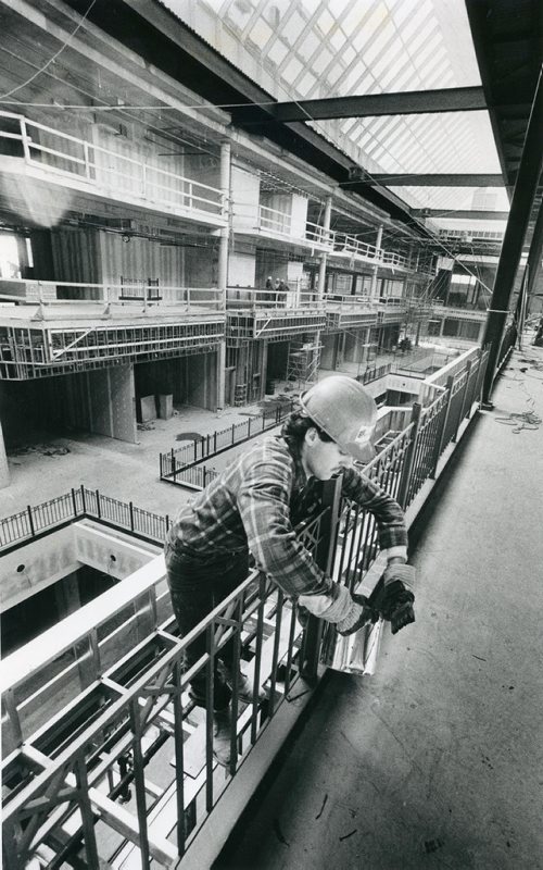 WINNIPEG FREE PRESS FILES
An ironworker puts the finishing touches on iron railings that surround ther open concourse area of Cadillac Fairview's Portage Place development. There are approximately 250 tradesmen preparing the $72-million mall for its mid-September opening. March 4, 1987.
