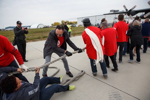 MIKE DEAL / WINNIPEG FREE PRESS
This years United Way fundraising Campaign Chair Colin Ryan, a Senior Vice President with BMO Nesbitt Burns, almost trips over a teammate during the 14th annual Plane Pull.
Over sixty teams from workplaces across Winnipeg test their might against a C-130 Hercules and Boeing 727 aircraft at the Red River College - Stevenson Campus in this years United Way fundraising Campaign's 14th annual Plane Pull.
170915 - Friday, September 15, 2017.