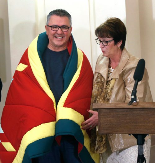 WAYNE GLOWACKI / WINNIPEG FREE PRESS

Chief Tony Powderhorn, Sayisi Dene First Nation was presented with a star blanket by Eileen Clarke, Indigenous and Northern Relations Minister at the signing ceremony in the Manitoba Legislative building Wednesday. The Manitoba government will be entering into a bilateral provincial Relocation Claim Lands Agreement with the Sayisi Dene First Nation. According to the news release  the bilateral Relocation Claim Lands Agreement will provide 13,054 acres of Crown land at Little Duck Lake to Indigenous and Northern Affairs Canada (INAC) to address the forced relocation of the Sayisi Dene people from their traditional territory.¤ The Crown land will be converted to reserve by INAC and is separate from any treaty land entitlements. Sept. 20 2017