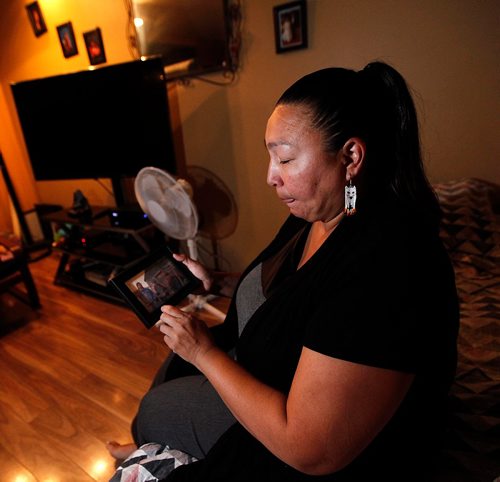 PHIL HOSSACK / WINNIPEG FREE PRESS  -  Betsy Mayham points to a photo of her brother Wednesday night. See Melissa Martin's story re: healing from suicide.  - Sept 20 2017