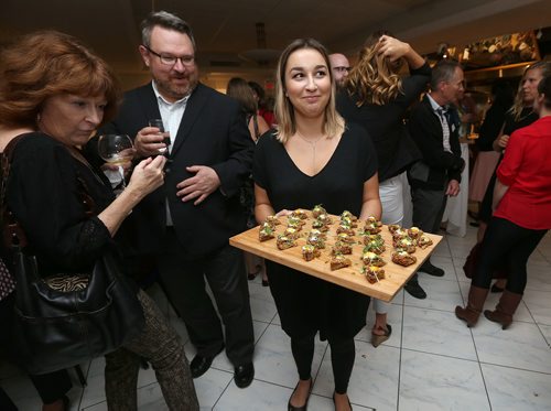 JASON HALSTEAD / WINNIPEG FREE PRESS

De Lucas server Rachael Agius brings out food during the 11th Great Manitoba Food Fight on Sept. 20, 2017 at De Lucas Cooking Studio. (See Social Page)