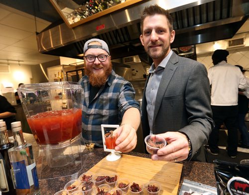 JASON HALSTEAD / WINNIPEG FREE PRESS

L-R: Jesse Hildebrand (Capital K Distillery assistant general manager) and Jeremy Silcox of Mr. Biltong Beef Jerky Co. show off their products during the 11th Great Manitoba Food Fight on Sept. 20, 2017 at De Lucas Cooking Studio. (See Social Page)