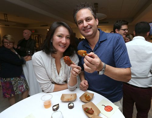 JASON HALSTEAD / WINNIPEG FREE PRESS

L-R: Attendees Susan Park and Peter Tines enjoy Little Bones Wings and the same wings with fellow comptetitor Cheeky Chutneys sauce during the 11th Great Manitoba Food Fight on Sept. 20, 2017 at De Lucas Cooking Studio. (See Social Page)