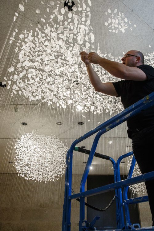 MIKE DEAL / WINNIPEG FREE PRESS
Vitaliy Yatsevych a conservator at the WAG makes some final adjustments to a piece by Hannah Claus, cloudscape, 2012 (double-matte reprography film, thread, PVA glue), one of the works of art by twenty-nine Indigenous artists for the Insurgence/Resurgence show at the Winnipeg Art Gallery.
170921 - Thursday, September 21, 2017.