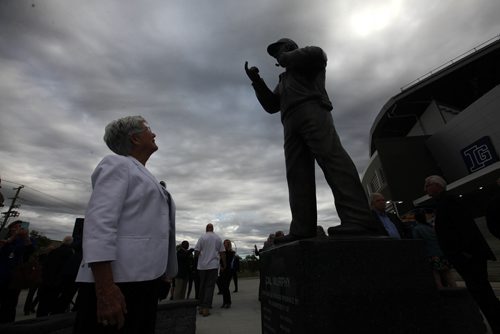 RUTH BONNEVILLE / WINNIPEG FREE PRESS

 The Winnipeg Blue Bombers  honour one of the most influential figures in the history of the organization, the late Cal Murphy, with the unveiling of a bronze statue in his likeness at Investors Group Field, at Gate 3  north/east
corner outside the stadium Thursday.
His wife, Joyce Murphy  (white jacket), family, Blue Bomber alumni, Mayor Brian Bowman and many others attending the unveiling.  

Photo of Cal Murphy's wife, Joyce Murphy looking up at the statue of her husband silhouetted against the grey sky after she unveiled it with family members Thursday.

SEPT 21, 2017
