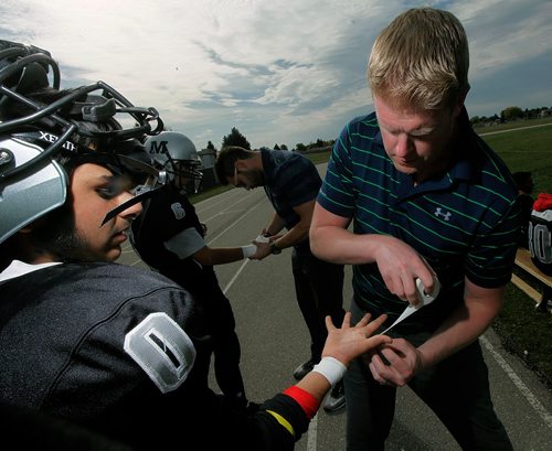 PHIL HOSSACK / WINNIPEG FREE PRESS  -   Athletic Therapist Scott Miller tapes a Maples Marauder football club before a game Thursday. See Randy Turner story re: Concussions.   - Sept 21 2017