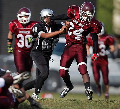 PHIL HOSSACK / WINNIPEG FREE PRESS  -   Daniel Mac Maroon #24 and Maples Marauder #66 Rajan Brar mix it up on the playing field Thursday afternoon. See Randy Turner story re: Concussions.   - Sept 21 2017