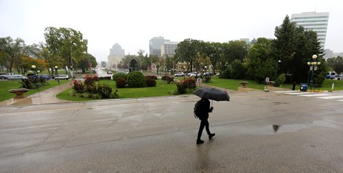 TREVOR HAGAN / WINNIPEG FREE PRESS
A person walks with an umbrella in front of the Legislative Building, Sunday, September 24, 2017.