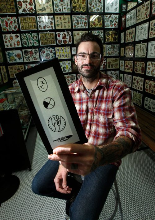 PHIL HOSSACK / WINNIPEG FREE PRESS  -  Bram Adey, tattoo artist at Rebel Waltz Tattoo, has a sheet of tattoo designs developed for Errol Greene. He is still getting requests to tattoo people with the designs. See Katie May story. - Sept 29, 2017