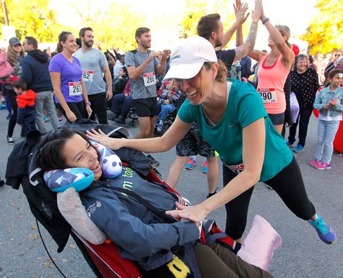 BORIS MINKEVICH / WINNIPEG FREE PRESS
Annual Free the Spirit Festival at St. Amant. The Running Room 5k run started with a record amount of participants. Care worker Amanda Campbell, right, gives a high 5 to Jessica Kowalson, left. Kowalson is in care through St. Amant and lives in a community home. Sept. 30, 2017