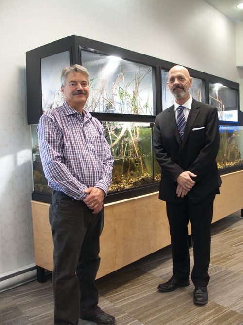 Canstar Community News Eugene Kenny (left) and Bruce Henderson stand before the new 325gallon aquarium ecosystem Concordia Village (1125 Molson St.).