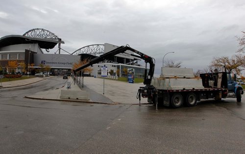 BORIS MINKEVICH / WINNIPEG FREE PRESS
A company drops off 2200lb concrete barriers at IGF to help security. The worker who didn't want his name used said there was 40 ordered and they were setting them up at various locations around the stadium.  Oct 3, 2017
