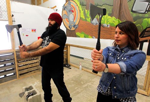 BORIS MINKEVICH / WINNIPEG FREE PRESS
Jen Zoratti, right, tries throwing an axe! In advance of the World Championship play downs with will be happening Oct. 9th and 10th. Jen gets a lesson from Ace Master Dan Blair, left, at Bad Axe Throwing, 1393 Border Street Unit #6. Oct 4, 2017