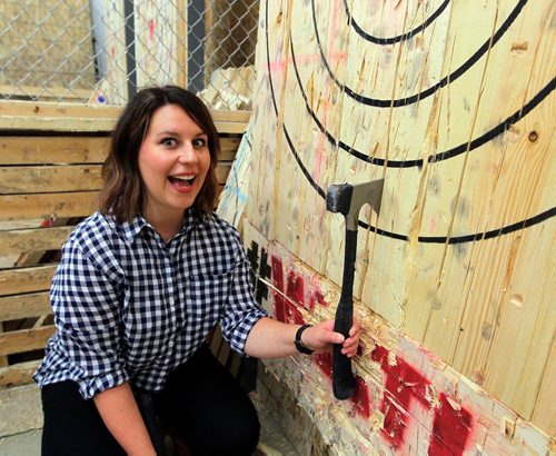 BORIS MINKEVICH / WINNIPEG FREE PRESS
Jen Zoratti tries throwing an axe! In advance of the World Championship play downs with will be happening Oct. 9th and 10th. Jen reacts to successfully landing an axe on the target at Bad Axe Throwing, 1393 Border Street Unit #6. Oct 4, 2017