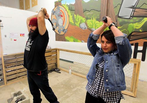 BORIS MINKEVICH / WINNIPEG FREE PRESS
Jen Zoratti, right, tries throwing an axe! In advance of the World Championship play downs with will be happening Oct. 9th and 10th. Jen gets a lesson from Ace Master Dan Blair, left, at Bad Axe Throwing, 1393 Border Street Unit #6. Oct 4, 2017