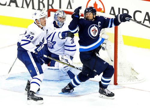 TREVOR HAGAN / WINNIPEG FREE PRESS
Toronto Maple Leafs' Morgan Rielly (44) catches Winnipeg Jets' Blake Wheeler (26) with a high stick during third period NHL hockey action on the opening night, Wednesday, October 4, 2017.