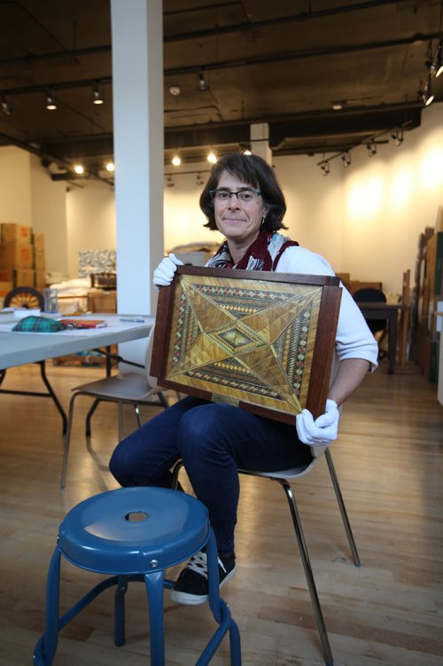 RUTH BONNEVILLE / WINNIPEG FREE PRESS

49.8 feature: Manitoba Craft Council and the Manitoba Craft Museum and Library.
The curator of the MB craft museum and library, Andrea Reichert, holds ornate tray crafted with straw that is just one of the unique pieces of art being unpacked in new space Wednesday.  
Feature story on the newly relocated C2 Centre for Craft thats opening up its doors with the Manitoba Craft Council and the Manitoba Craft Museum and Library at 329 Cumberland Ave.  

The story is about how this new space is filling in the craft scene and about the craft vs. art debate and why they need their own space in the first place.

Photos of:
 them unpacking and moving into the new space at 1-329 Cumberland ave., MB craft museum curator (Andrea Reichert), photos of MB Craft Council Director (Tammy Sutherland), Museum Gallery items in showcase, items being unpacked for 1st show (show is titled "best"), craft book library and locally made craft pieces like, colander bowl and beautifully handcrafted, usable, teapots that will be for sale in their onsite store.  

The curator of the MB craft museum and library, Andrea Reichert, is the contact for story. 
See Erin Lebar story.
Oct 04, 2017