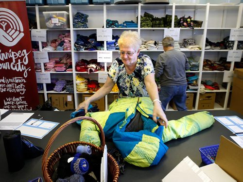 WAYNE GLOWACKI / WINNIPEG FREE PRESS

Volunteer Cyndy Klinkhammer gets a winter coat ready for a needy child in the distribution centre Thursday for the launch of the United Way's 2017-18 Koats for Kids Program. Their inventory is low and the need is huge for kids winter gear.  New and gently used coats, hats, mitts, scarves, boots and skipants for infants and kids can be dropped off at Winnipeg Fire Paramedic Stations and all Perths Drycleaners locations. United Ways Koats for Kids collects and distributes over 6,000 coats and many thousands of other new and gently-used winter outerwear items donated by generous Winnipeggers each year. Oct.5 2017
