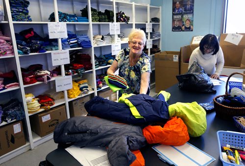 WAYNE GLOWACKI / WINNIPEG FREE PRESS

Volunteer Cyndy Klinkhammer gets a winter coat, mitts and scarf ready for a needy child in the distribution centre Thursday for the launch of the United Way's 2017-18 Koats for Kids Program. Their inventory is low and the need is huge for kids winter gear.  New and gently used coats, hats, mitts, scarves, boots and skipants for infants and kids can be dropped off at Winnipeg Fire Paramedic Stations and all Perths Drycleaners locations. United Ways Koats for Kids collects and distributes over 6,000 coats and many thousands of other new and gently-used winter outerwear items donated by generous Winnipeggers each year. Oct.5 2017
