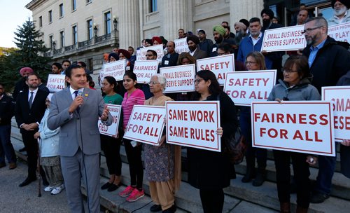 WAYNE GLOWACKI / WINNIPEG FREE PRESS

At left, Wab Kinew, Manitoba NDP leader with cabbies and supporters rallying in front of the Legislative building to oppose Uber Bill Thursday. Nick Martin story Oct.5