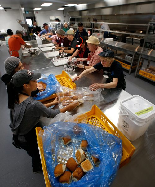 WAYNE GLOWACKI / WINNIPEG FREE PRESS

Siloam Mission volunteers prepare a traditional Thanksgiving feast for guests at the grand opening of their new kitchen, dining room and drop-in centre at 303 Stanley St. on Friday.  Volunteers expect to serve 1,000 meals in this Siloam Mission facility right behind their Princess St. location. The brand new dining room seats more than 400 people, this opening completes phase one of a two-part development plan.  Oct.6 2017